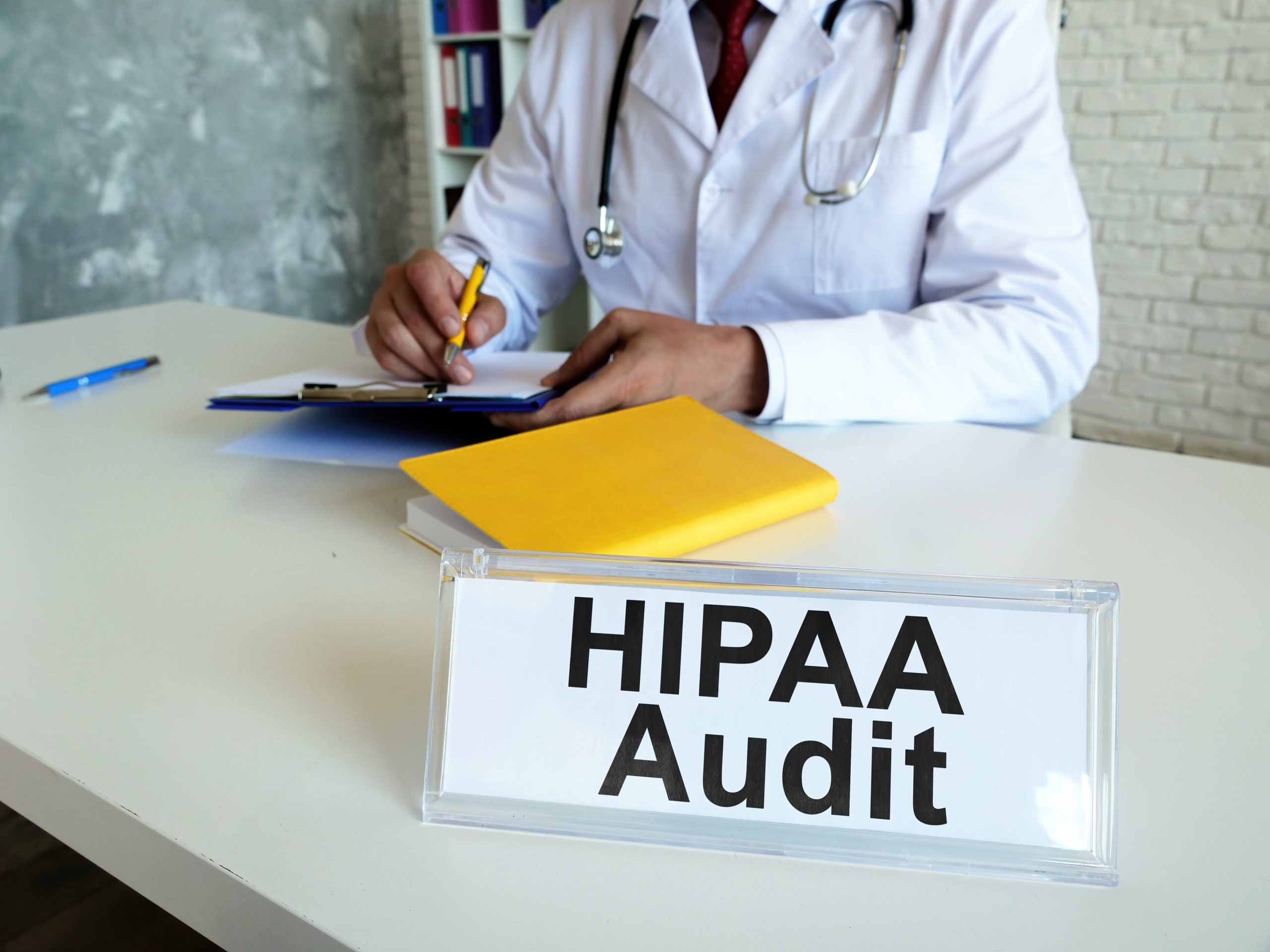 HIPAA audit concept. The doctor works with medical documents.